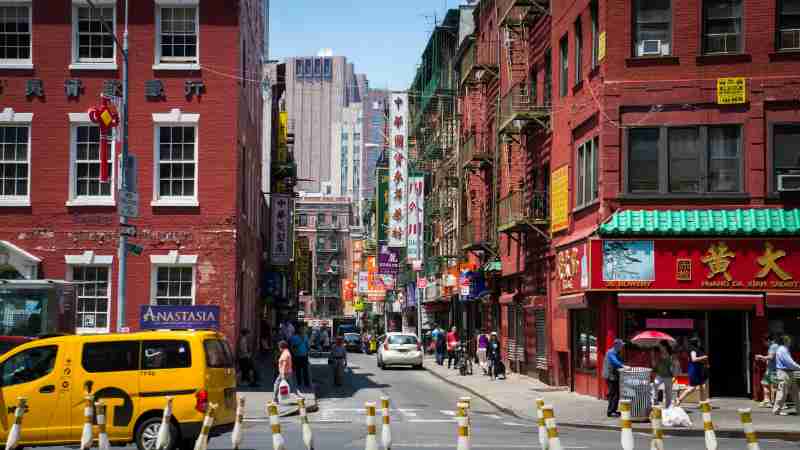 Busy daytime street scene in Chinatown, New York City with pedestrians, shops, and taxis., tags: seoul north - pexel